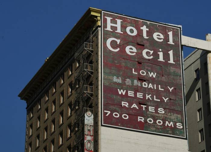 A sign on worn building that reads, &quot;Hotel Cecil low daily weekly rates 700 rooms&quot;