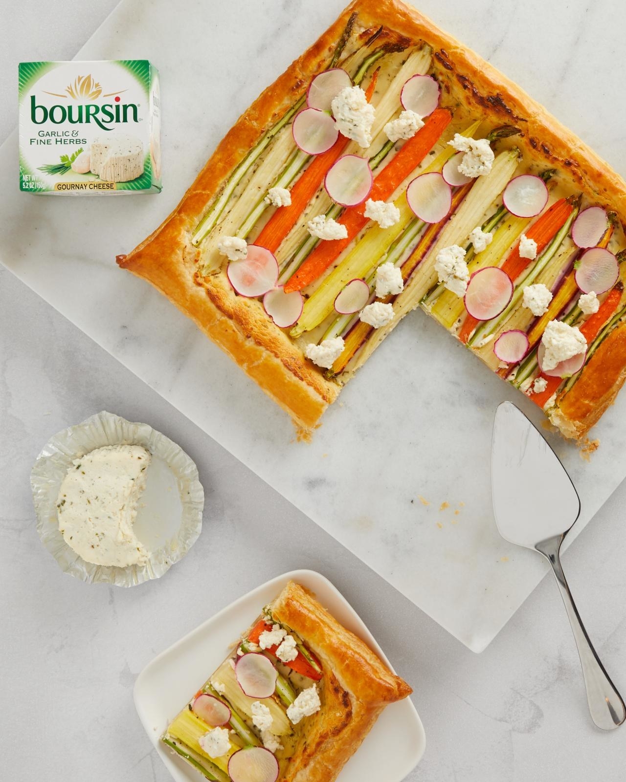 Sliced tart covered with a variety of vegetables and Boursin® Cheese