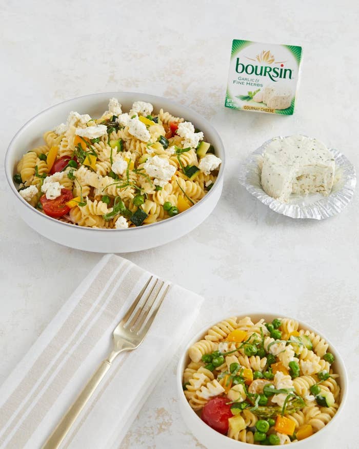 Two places of rotini pasta with several vegetables