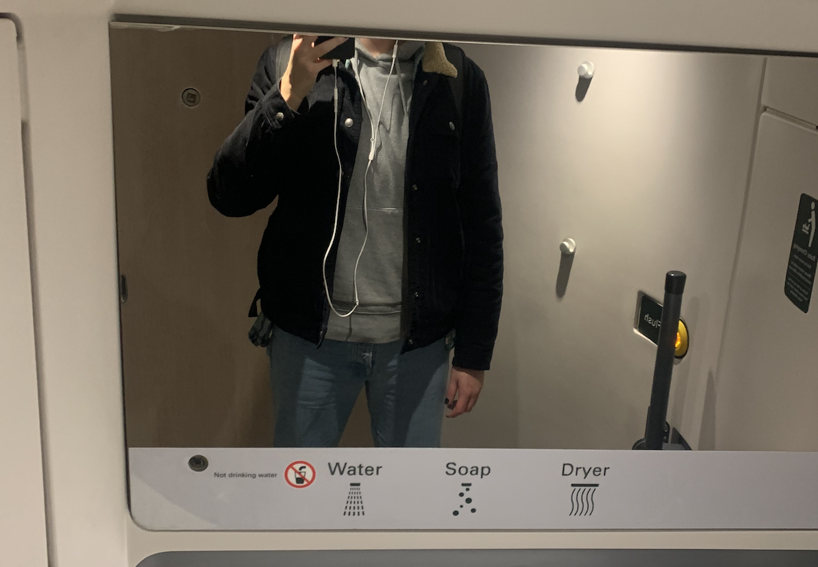 Guy stands in front of train mirror but you can&#x27;t see his head