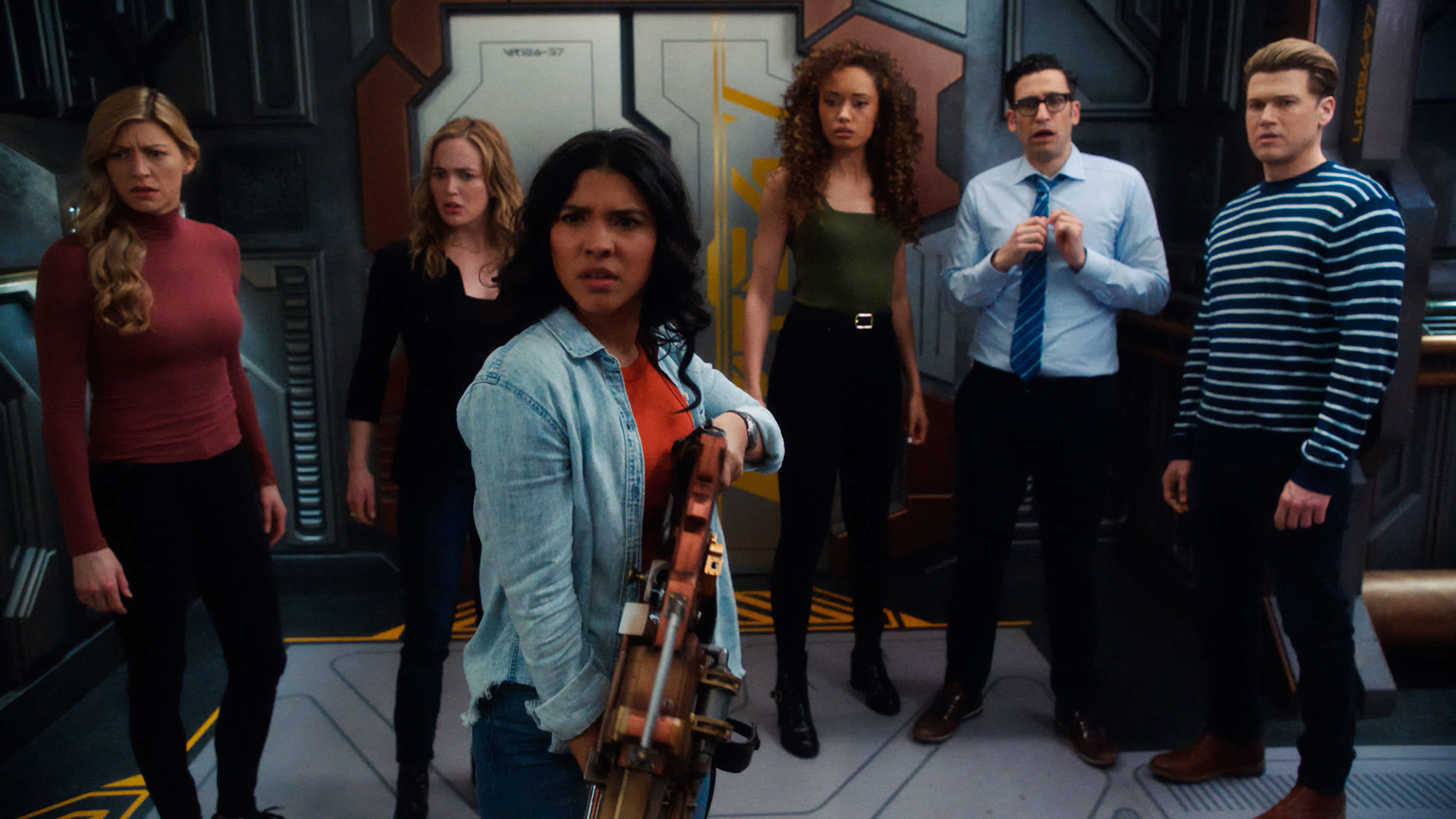 The Legends looking confused at something off camera: from left to right, Ava, Sarah, Spooner holding a gun, Astra, Gary, and Nate