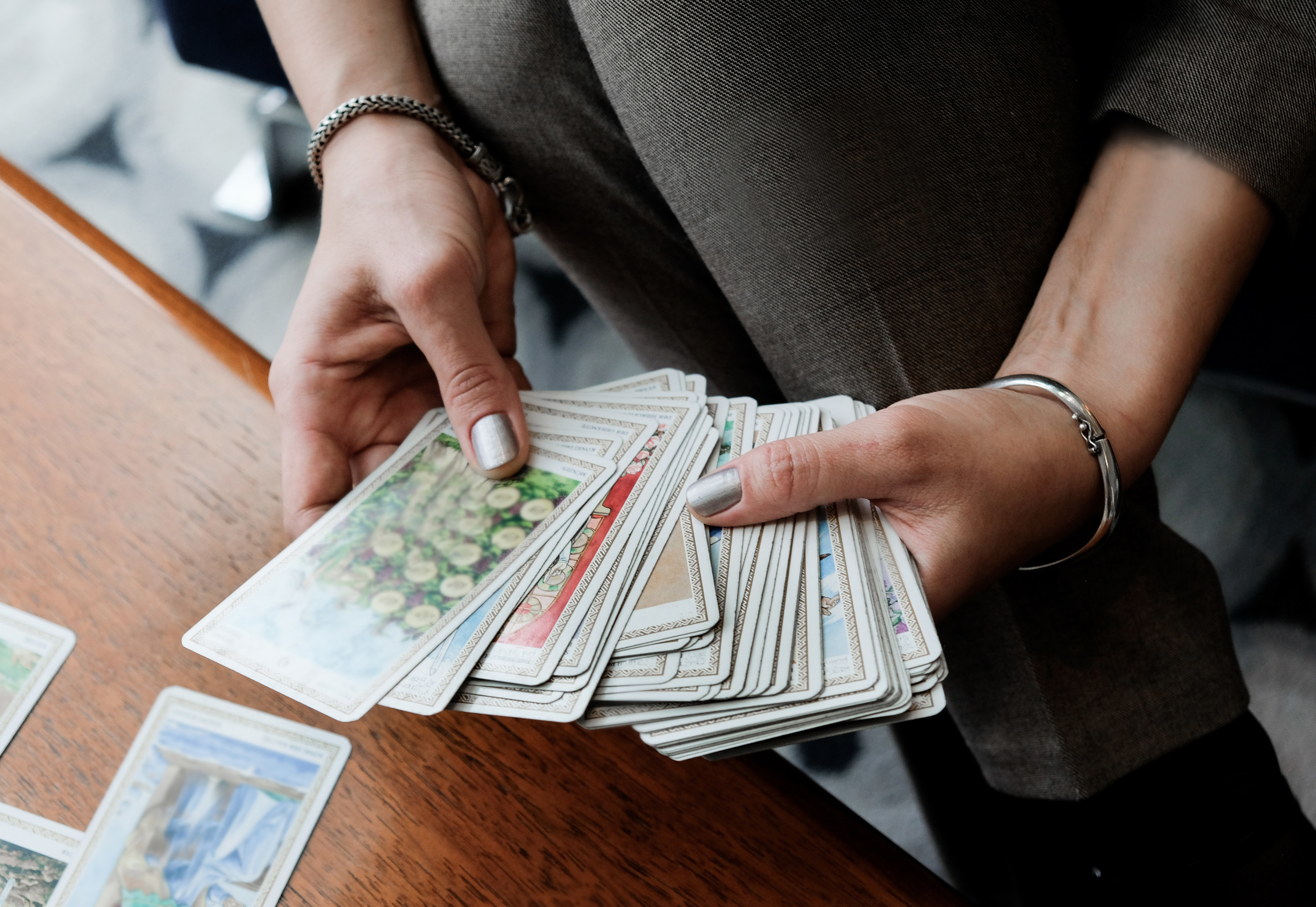 A person holding a deck of tarot cards