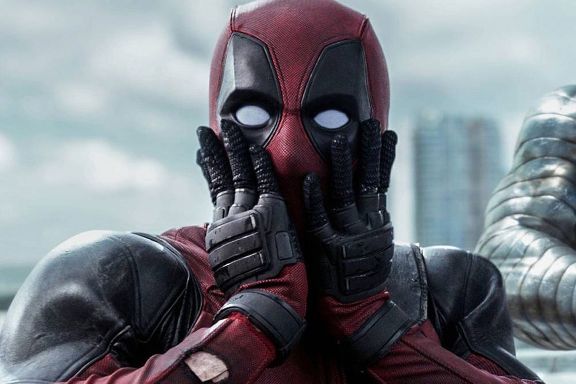 Deadpool in his costume pulling a mock shocked face, with wide eyes and his hands on either side of his face