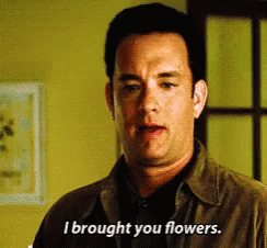 Tom Hanks holding flowers saying, &quot;I brought you flowers&quot;