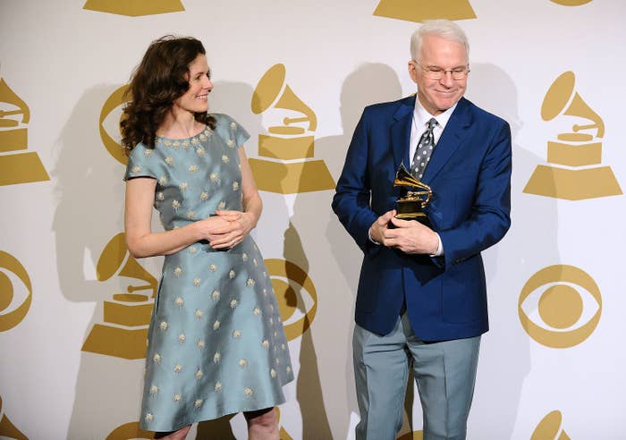 Steve Martin smiles as he poses with his award