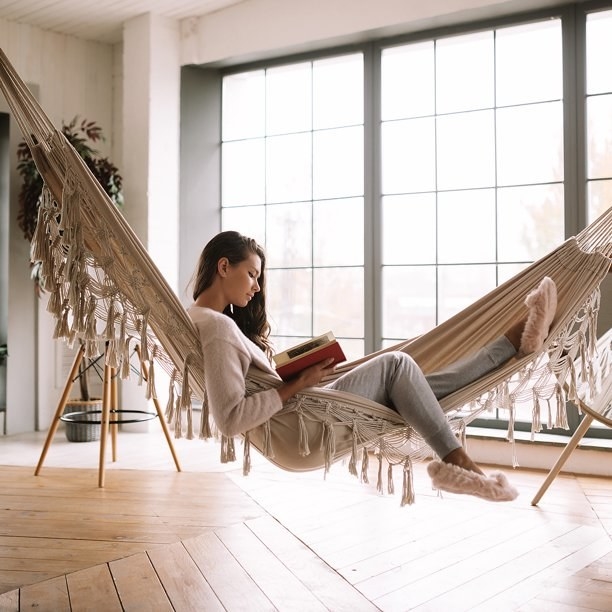 Model reading book on fringed hammock