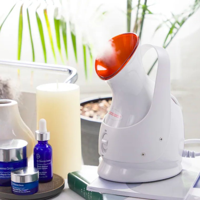 Facial steamer surrounded by various other products