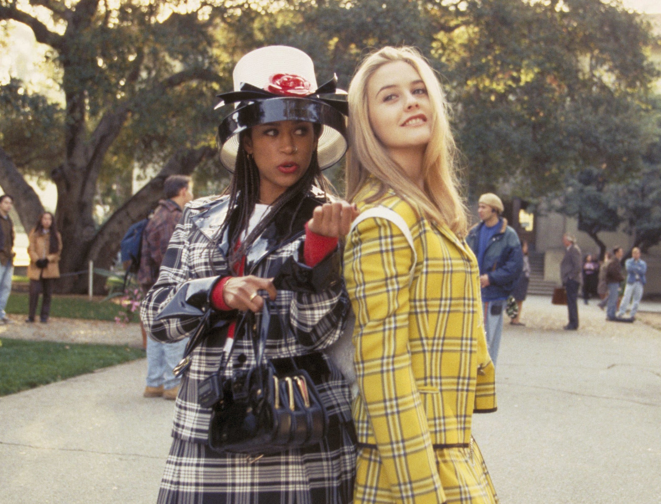 Two girls in plaid suits on a campus