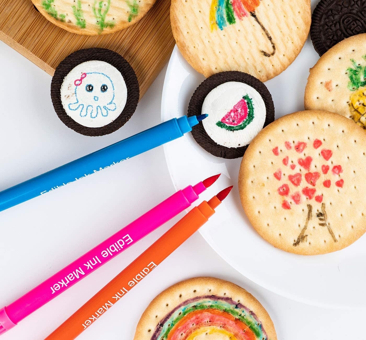 a set of colourful edible food markers next to crackers