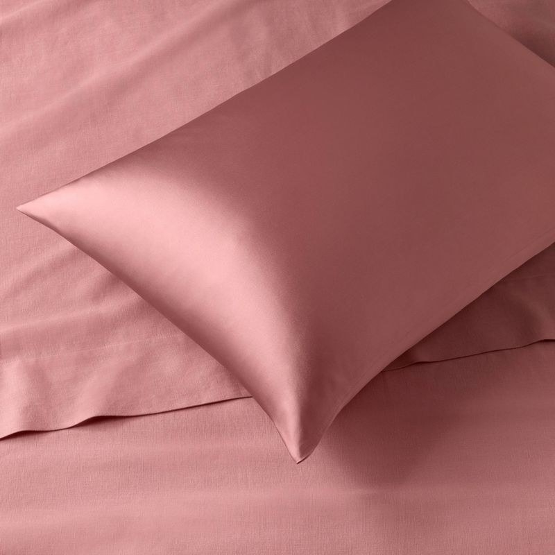 The rose pink silk pillowcase on pillow