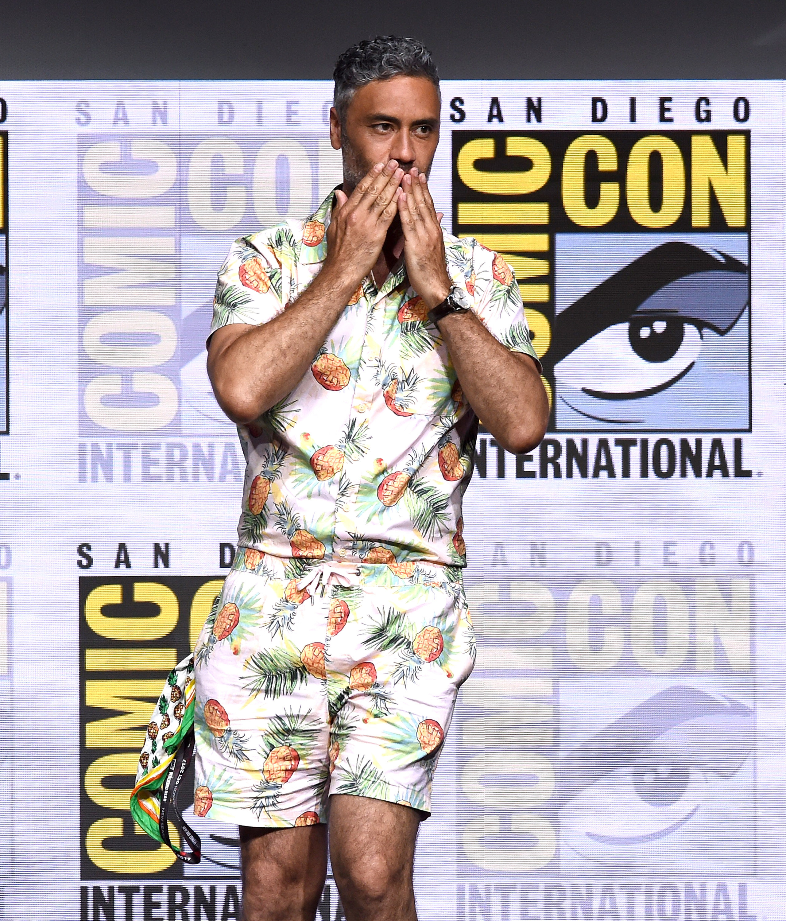 Taika Waititi in a shirt and short set covered in pineapples