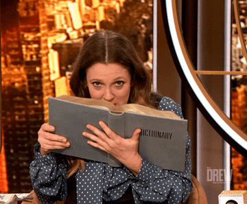 Drew Barrymore sniffing a book