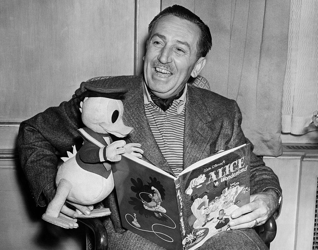 Walt Disney holding a stuffed Donald Duck and &quot;Alice in Wonderland&quot; book
