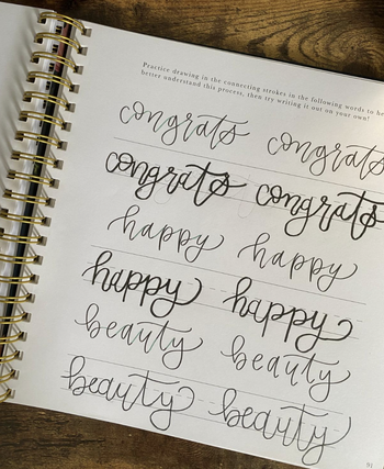 reviewer practicing the same words in calligraphy multiple times on the page