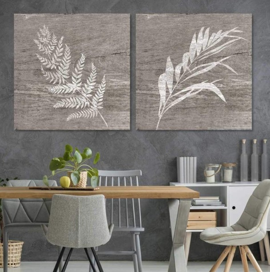 A set of two grey foliage wooden canvas art in a kitchen