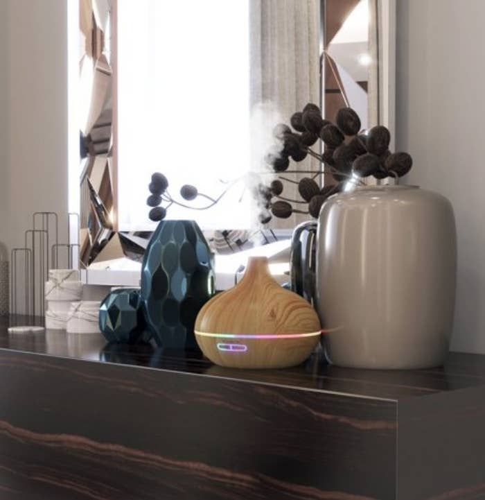 A wooden aromatherapy diffuser atop a counter