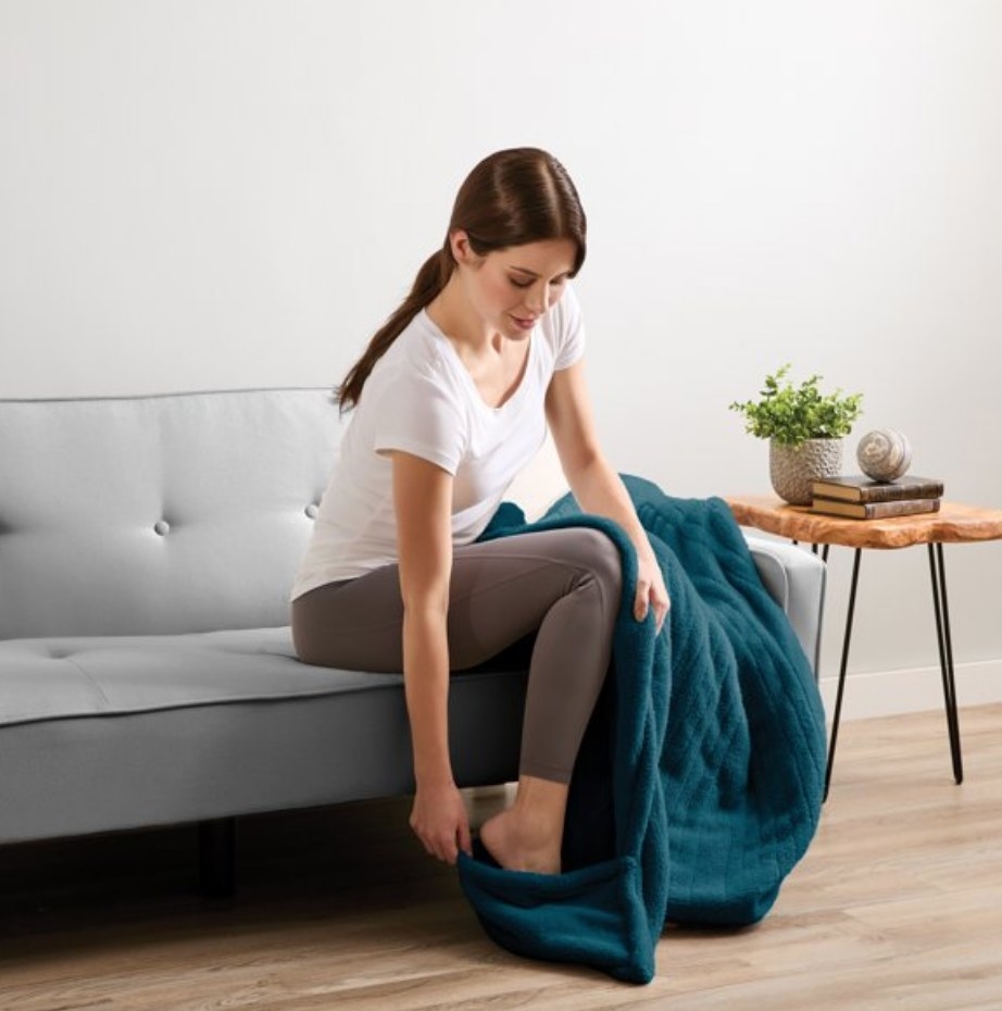 A model using a blue electric throw blanket