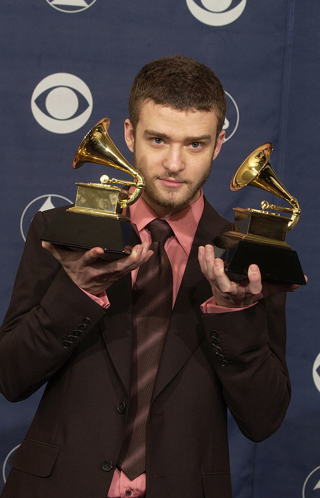 Justin Timberlake holds up two awards