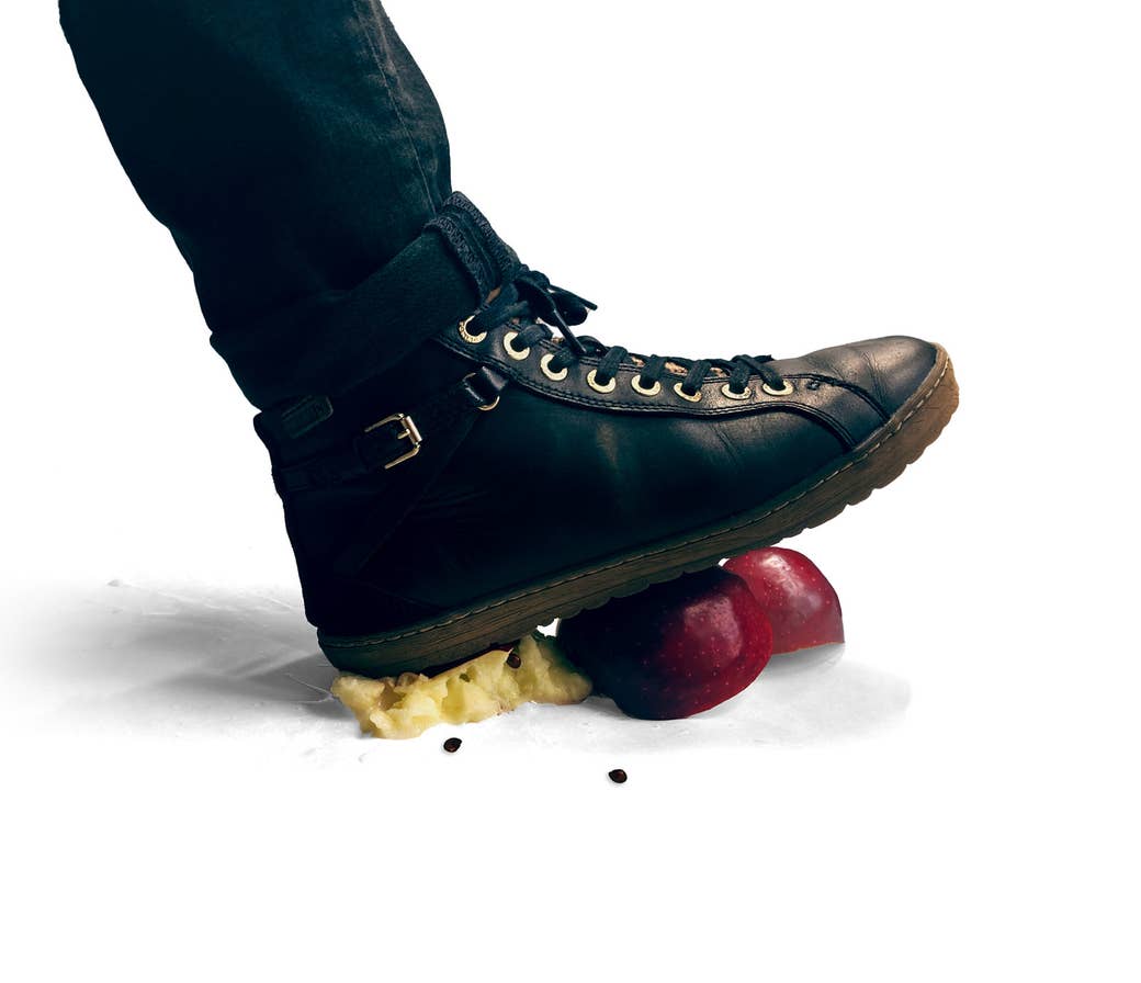 A photo illustration of a shoe crushing an apple