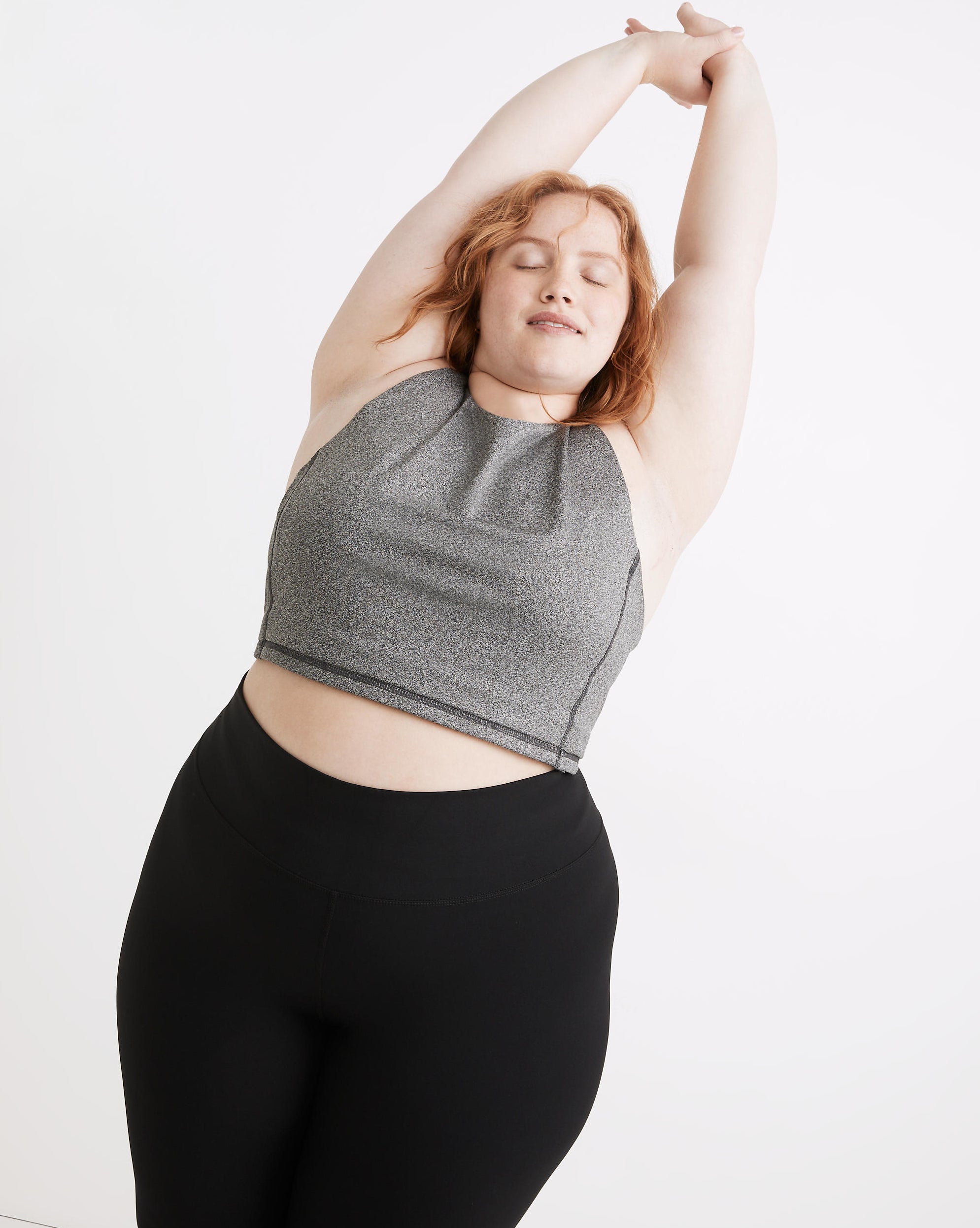 Model wearing the grey heather crop top with black leggings