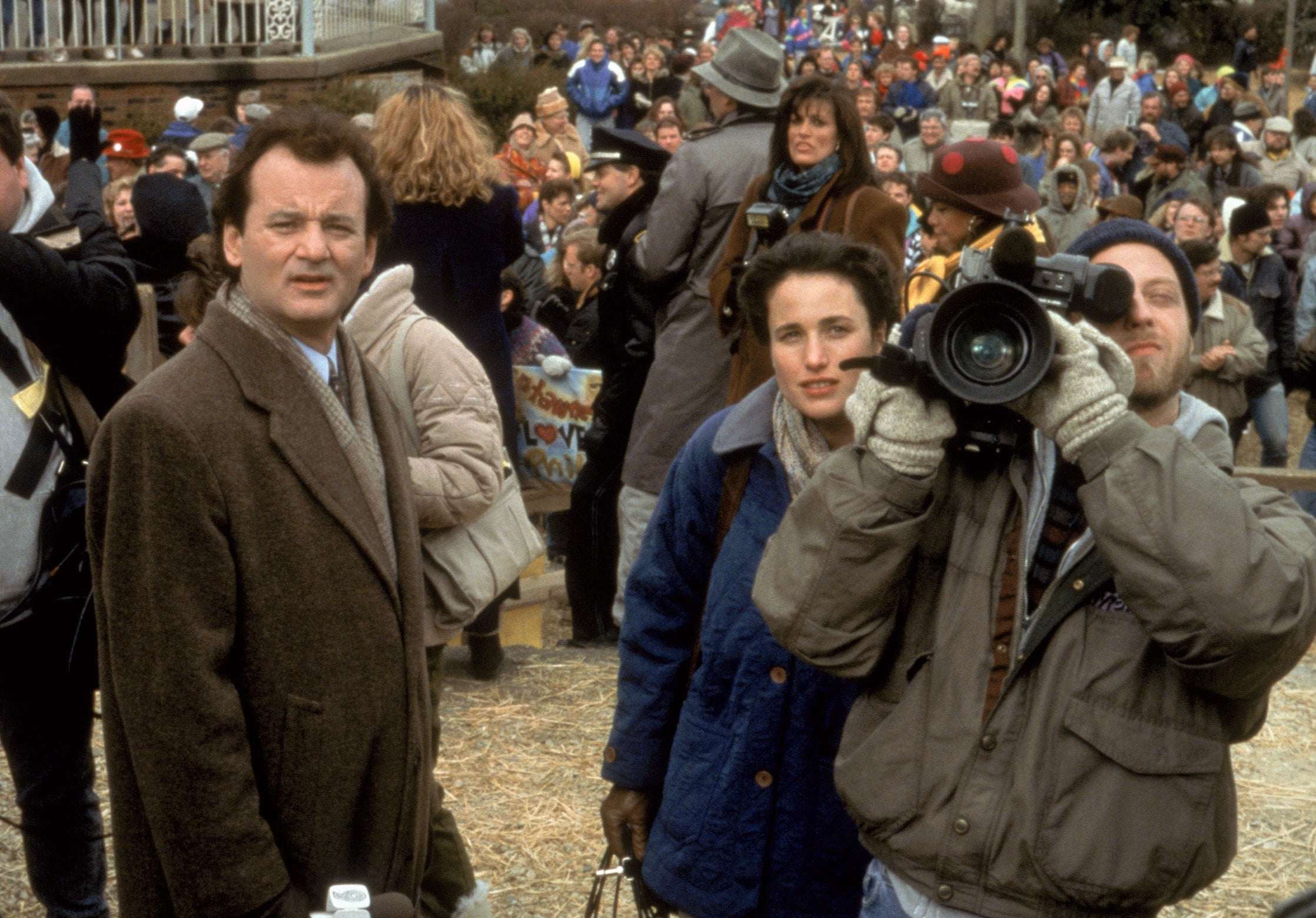 News reporters and Bill Murray and Andie MacDowell in a crowd