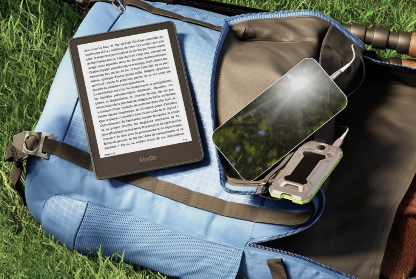 The black kindle resting on a backpack in the grass