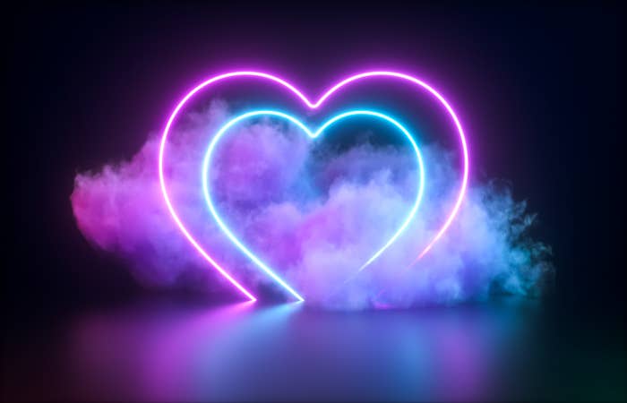 Two neon lights form the shape of a heart inside a heart