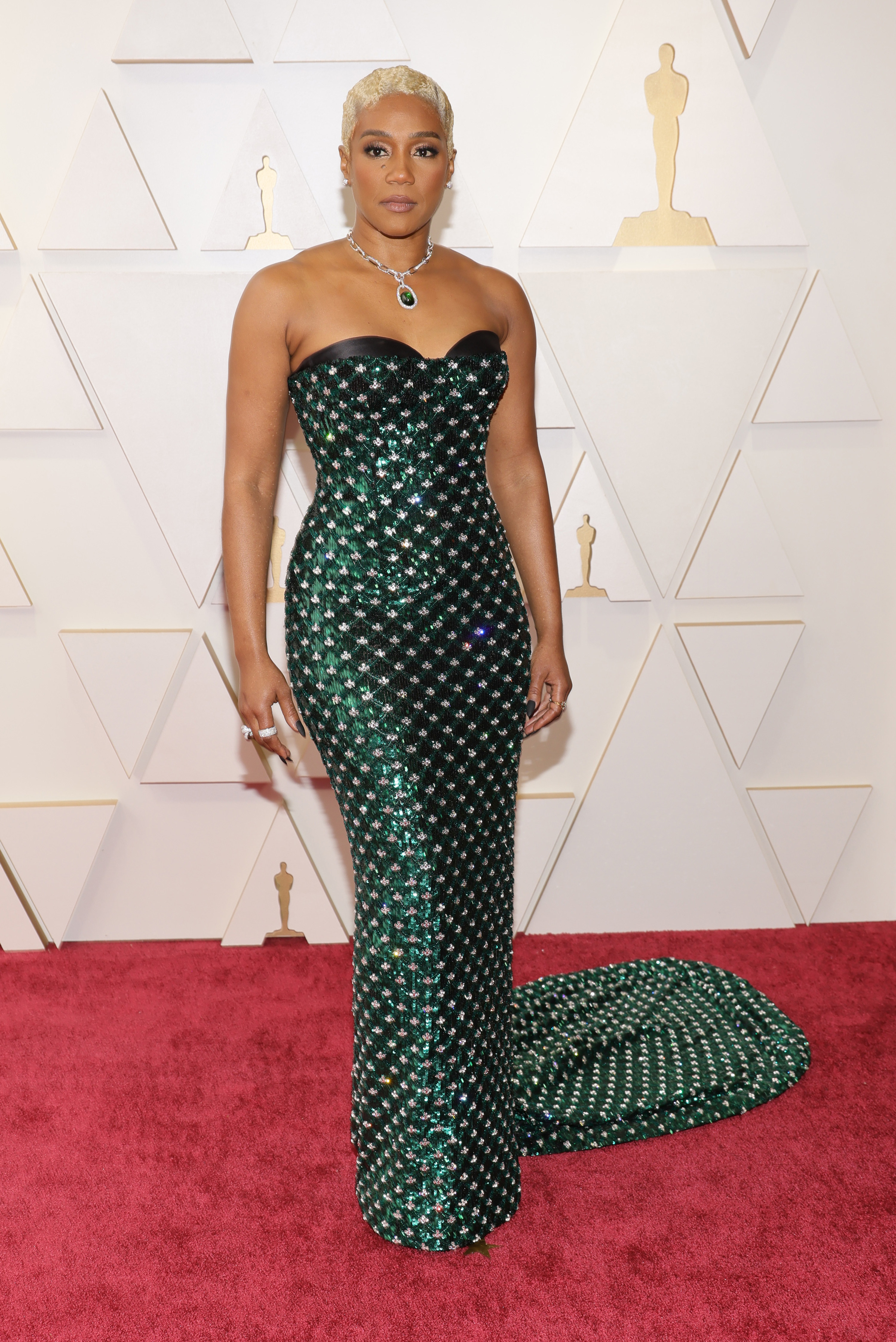 Tiffany posing at the Oscars red carpet in a strapless sequined gown