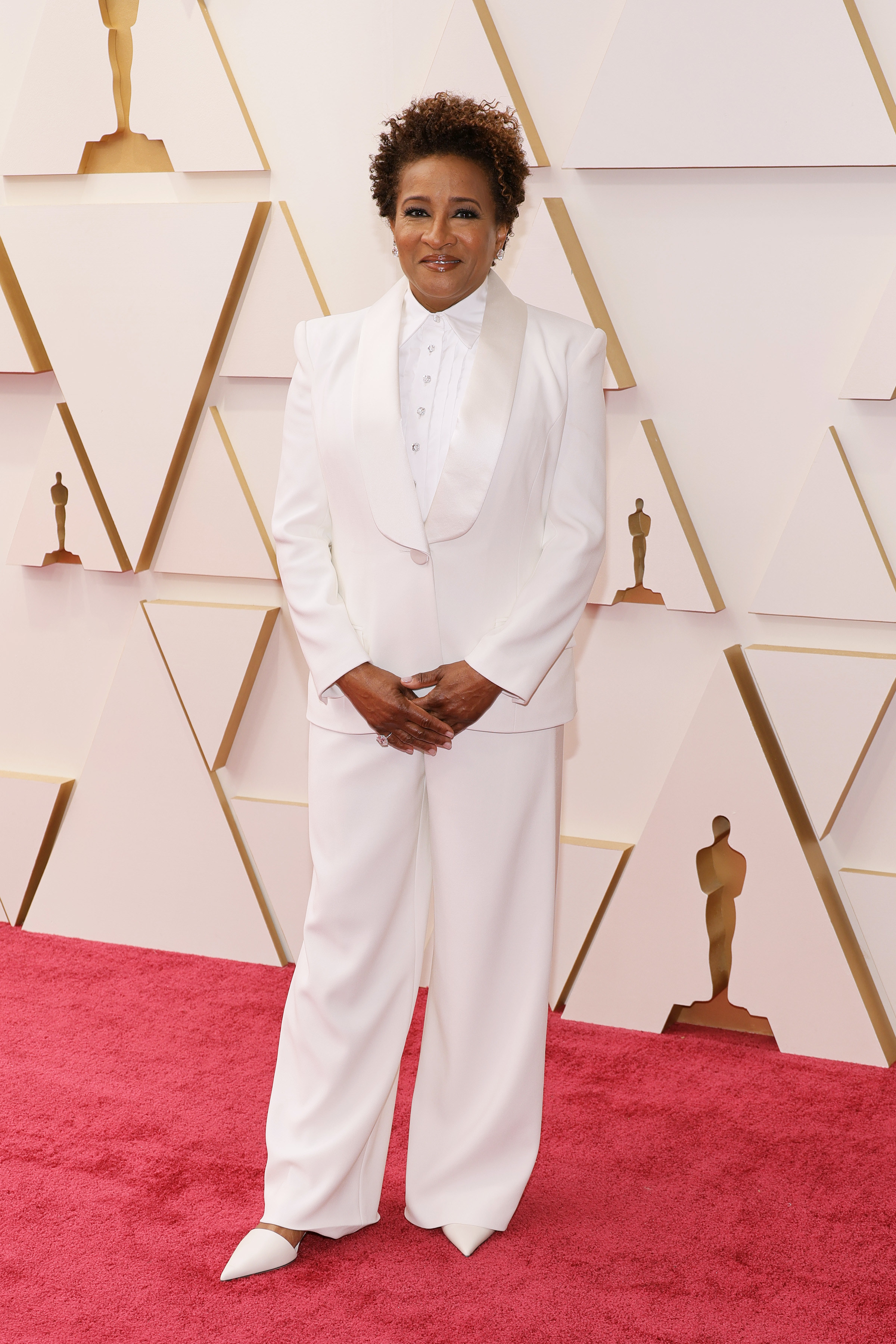 Wanda posing on the red carpet in a wide-legged pantsuit and matching heels