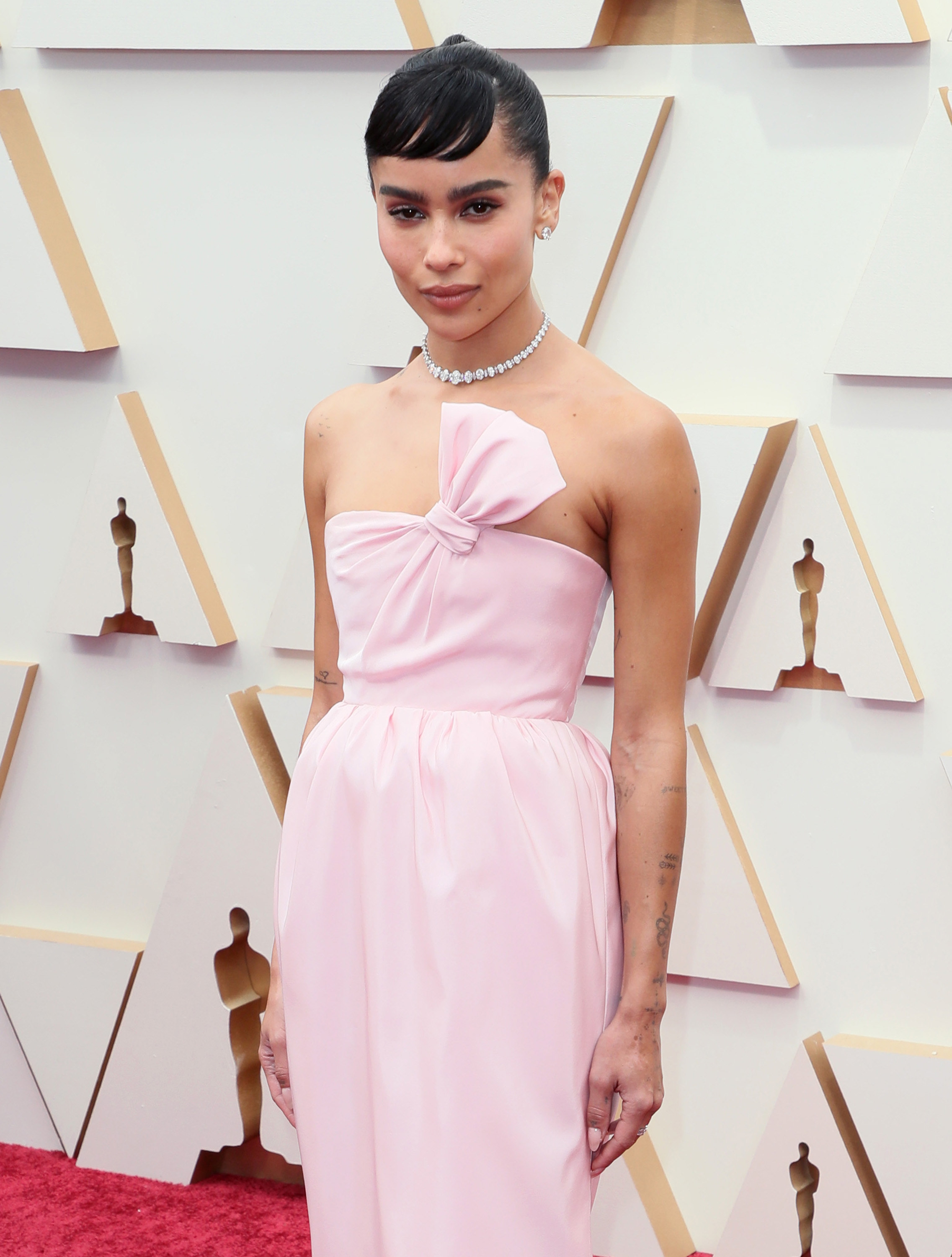 Zoë posing on the Oscars red carpet in a strapless gown