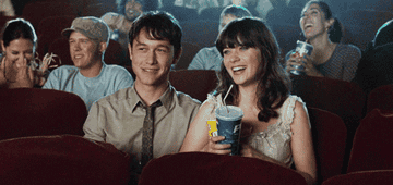 Joseph Gordon-Levitt and Zooey Deschanel laughing in a movie theater in &quot;500 Days of Summer&quot;