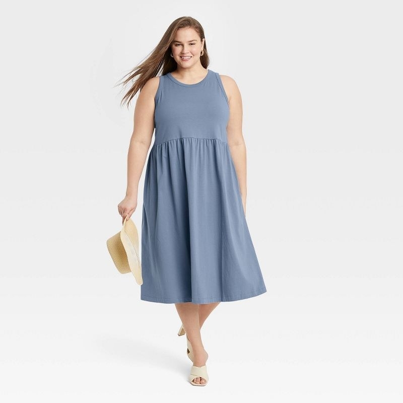 Model wearing the blue sleeveless crew neck dress with heeled sandals