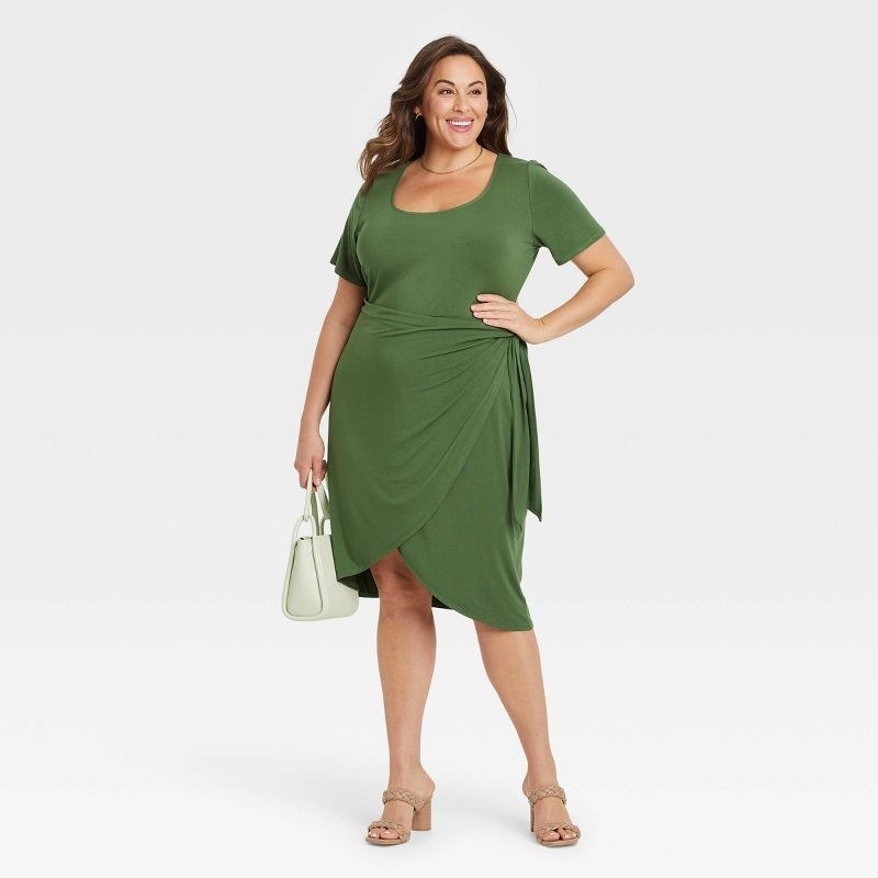 Model wearing the green knee-length dress