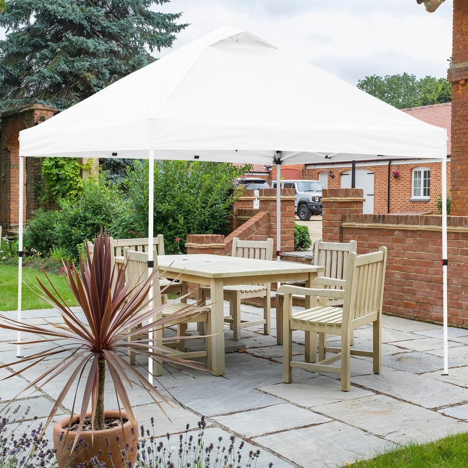 The white vented steel frame pop-up canopy