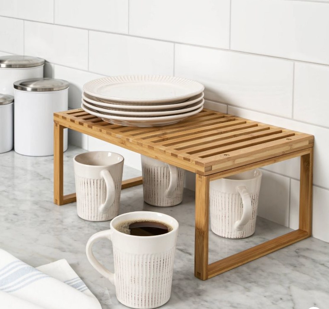 A bamboo stackable shelf on a counter