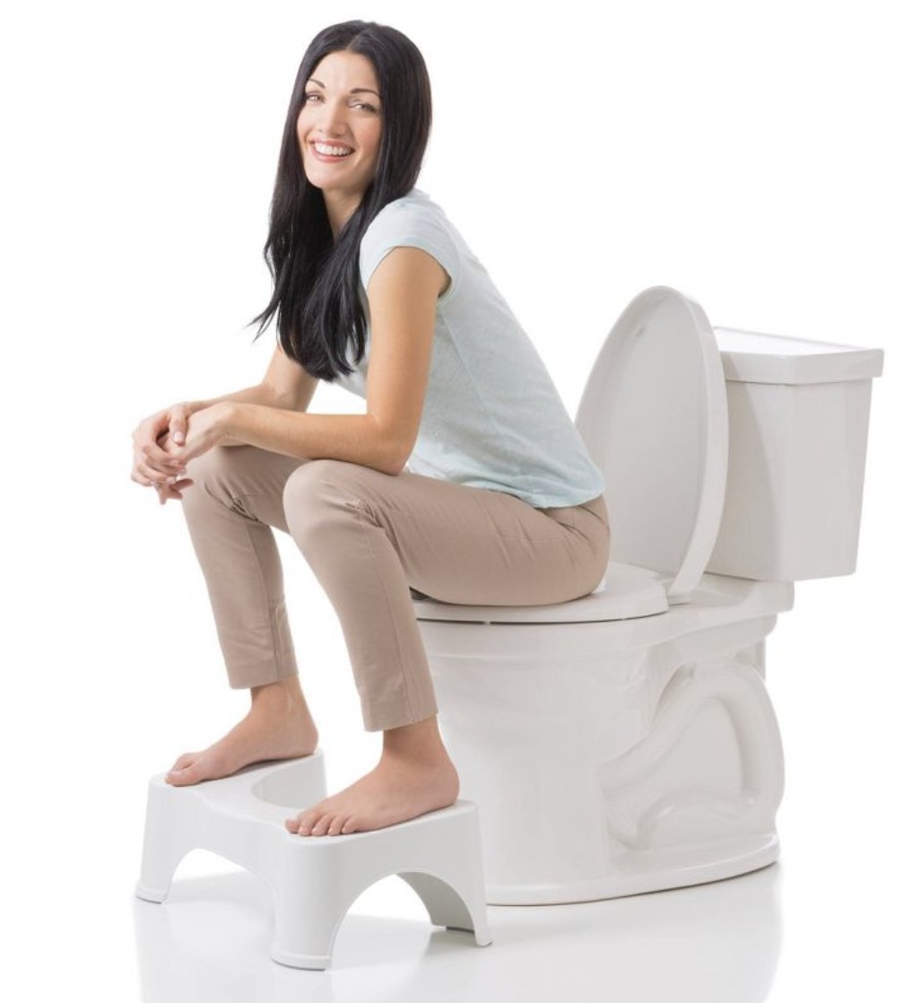 A woman using a squatty potty