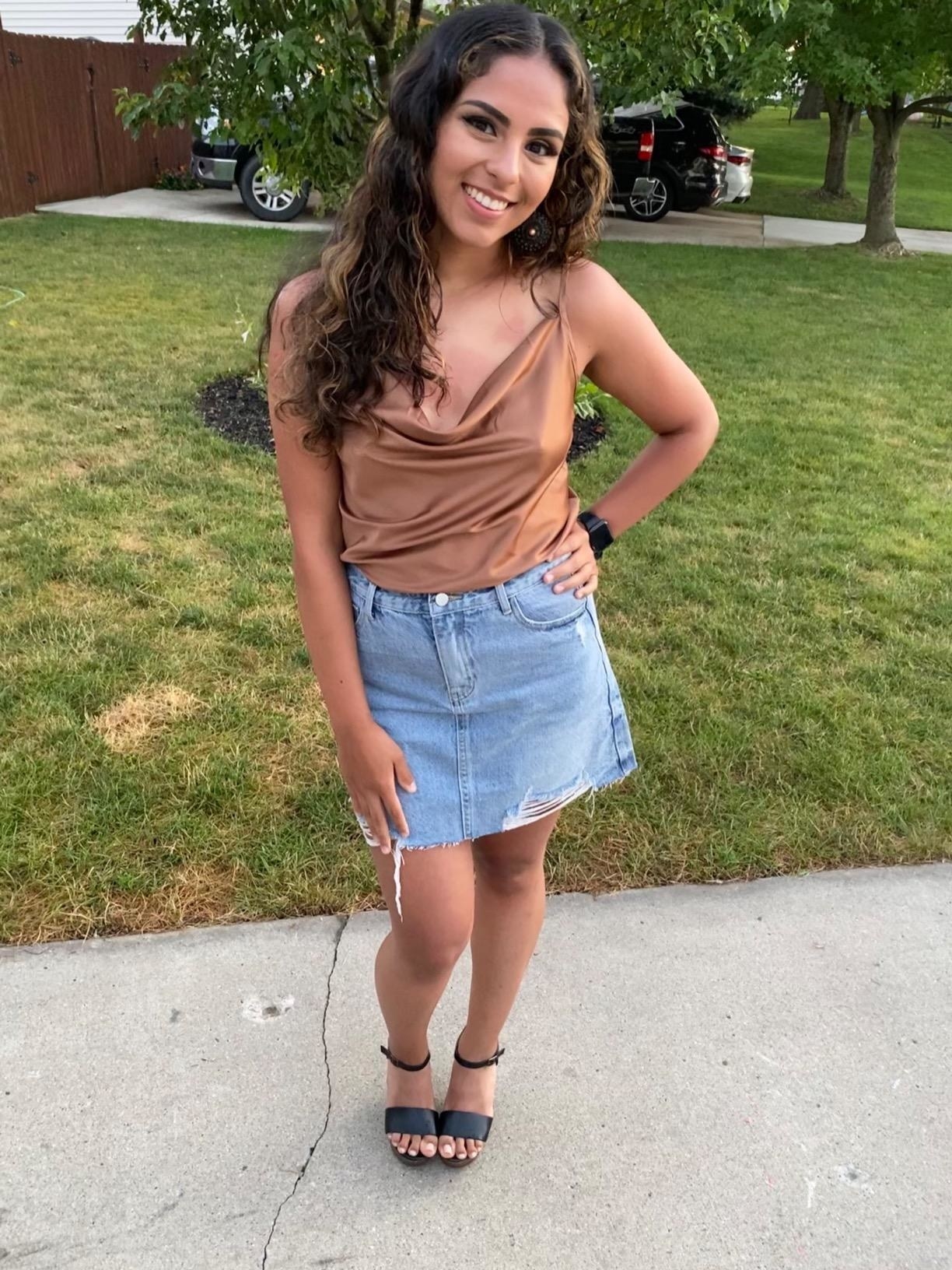 the top in brown paired with a denim skirt