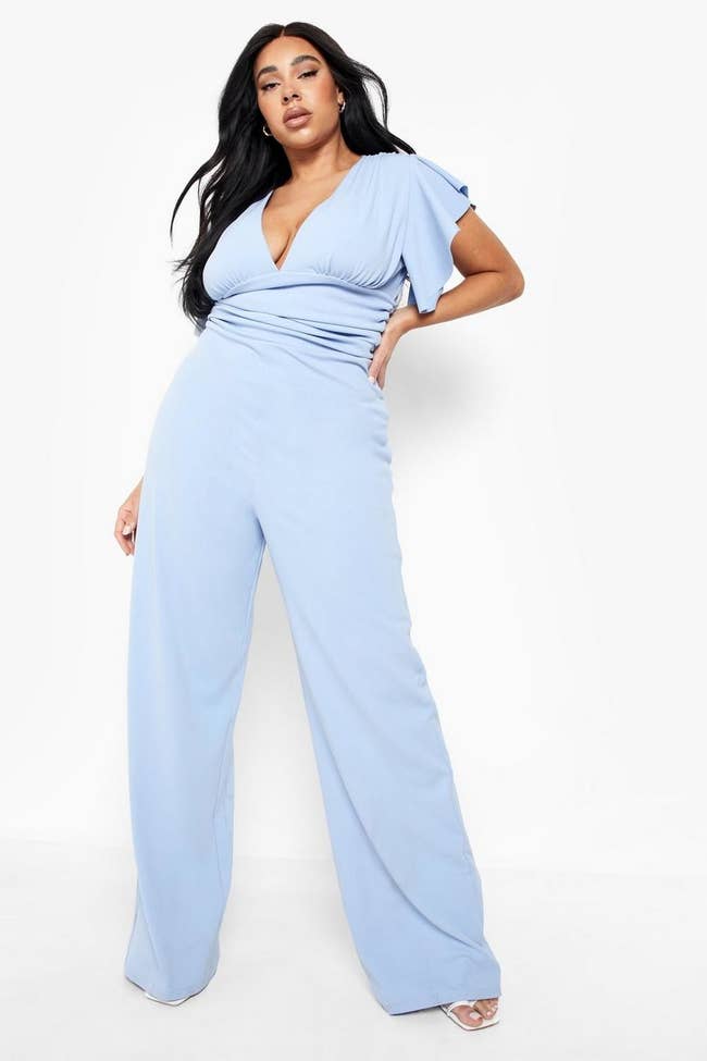 a model wearing the baby blue jumpsuit showing the wide leg and long length