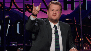James Corden putting up the rock and roll horns and pretending to headbang