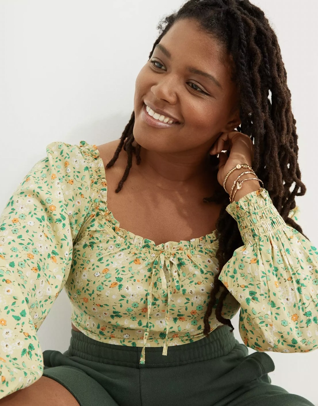 Model wearing the green floral smocked top