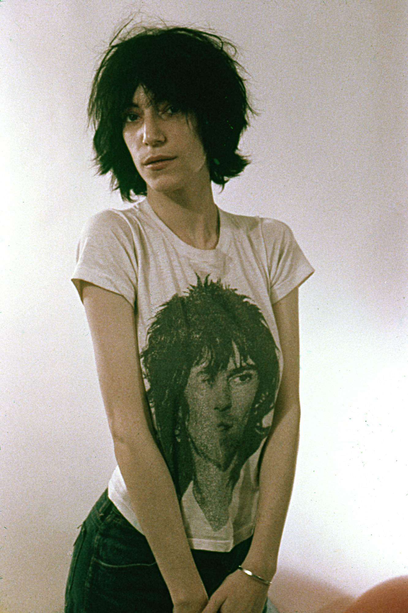 Smith posing for a portrait with a Keith Richards t-shirt on in 1974
