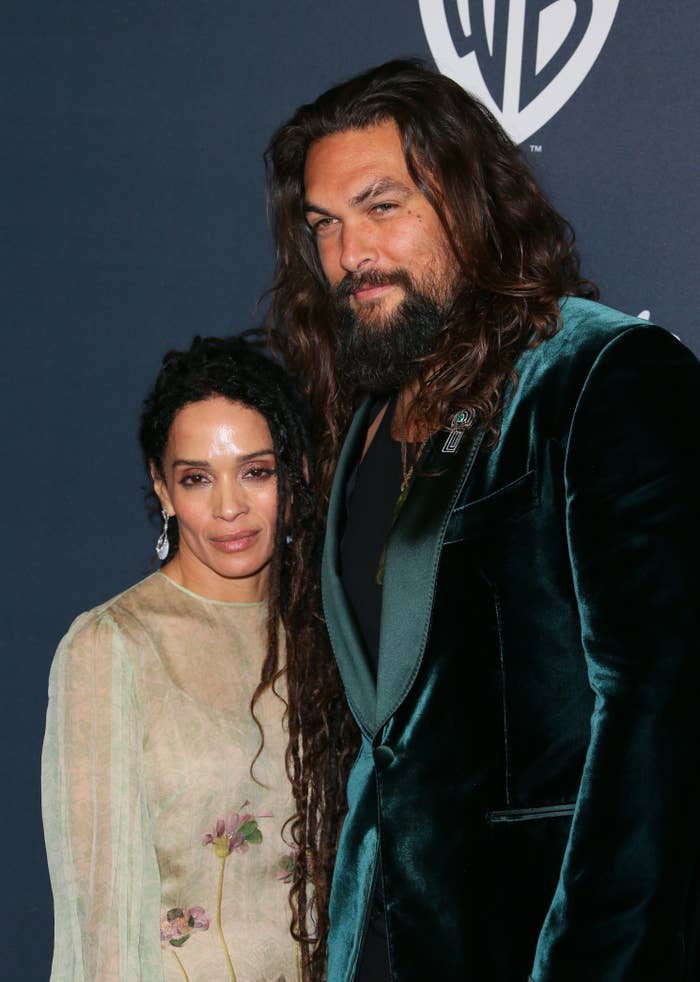 Jason and Lisa smiling on a red carpet