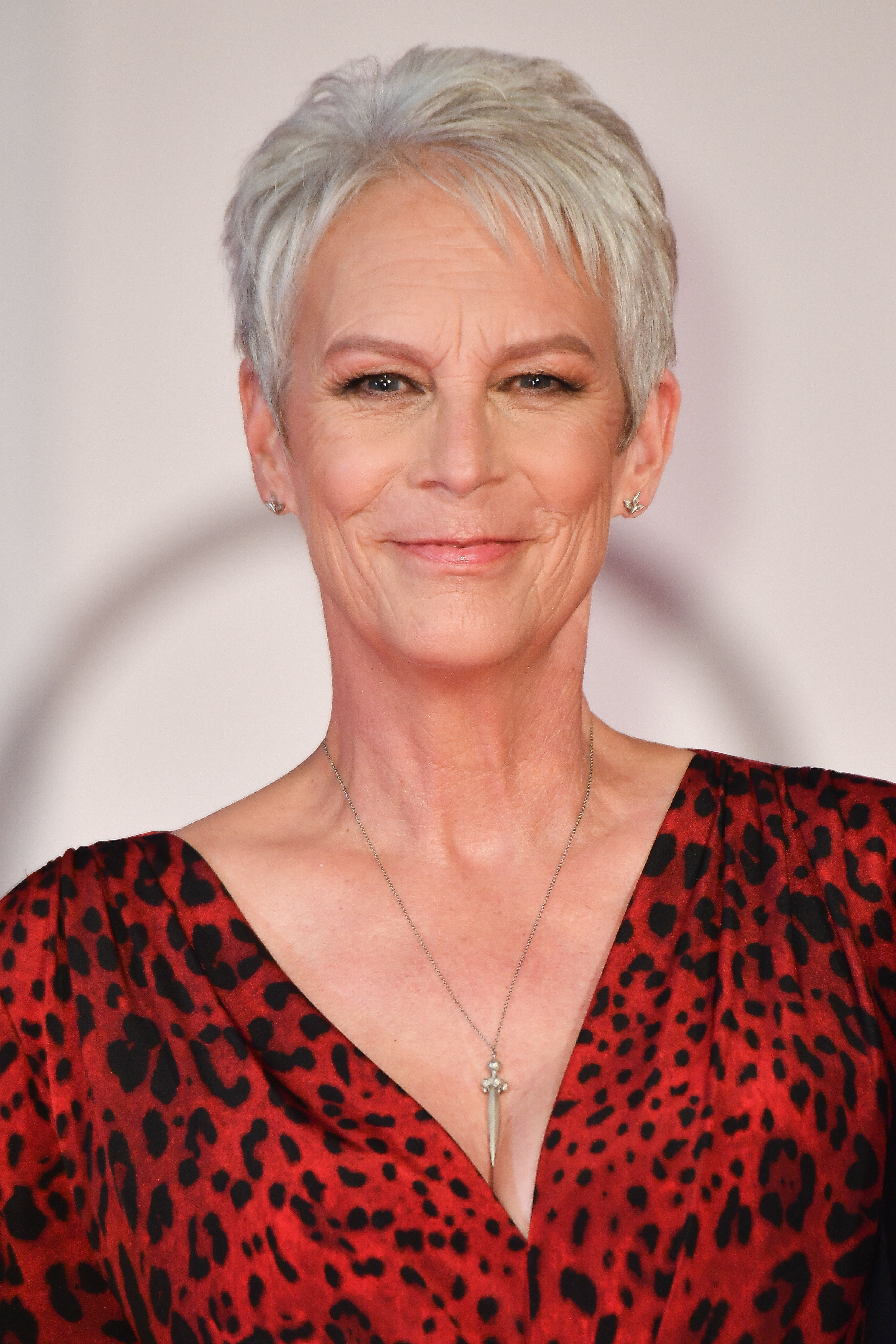 Close up of Jamie Lee Curtis smiling at a camera
