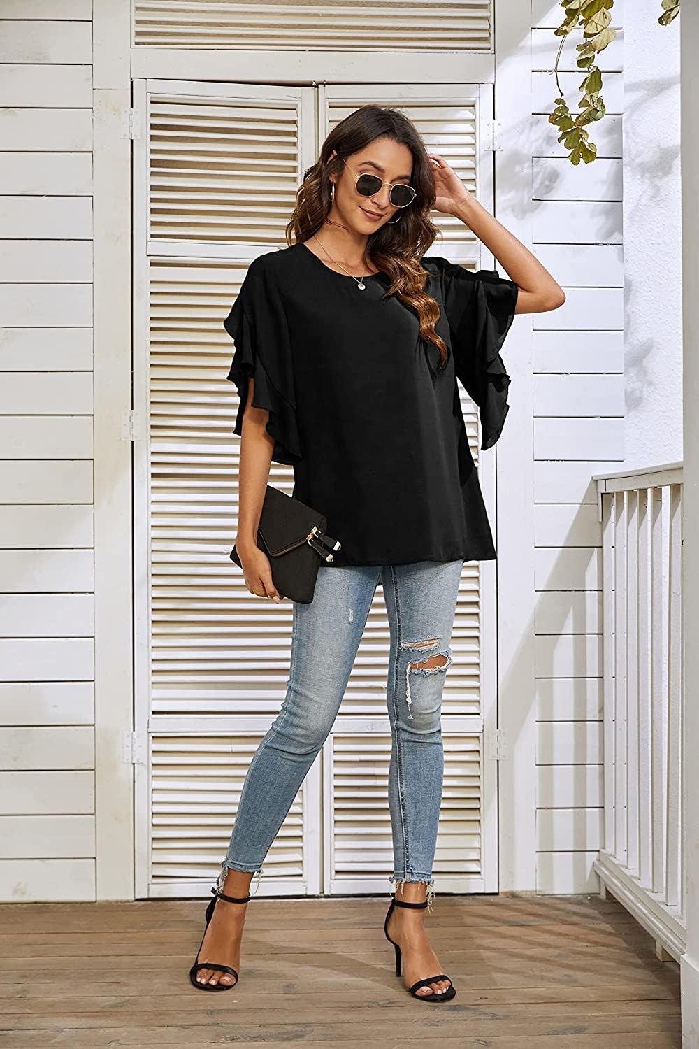 Model wearing the black long tunic over jeans