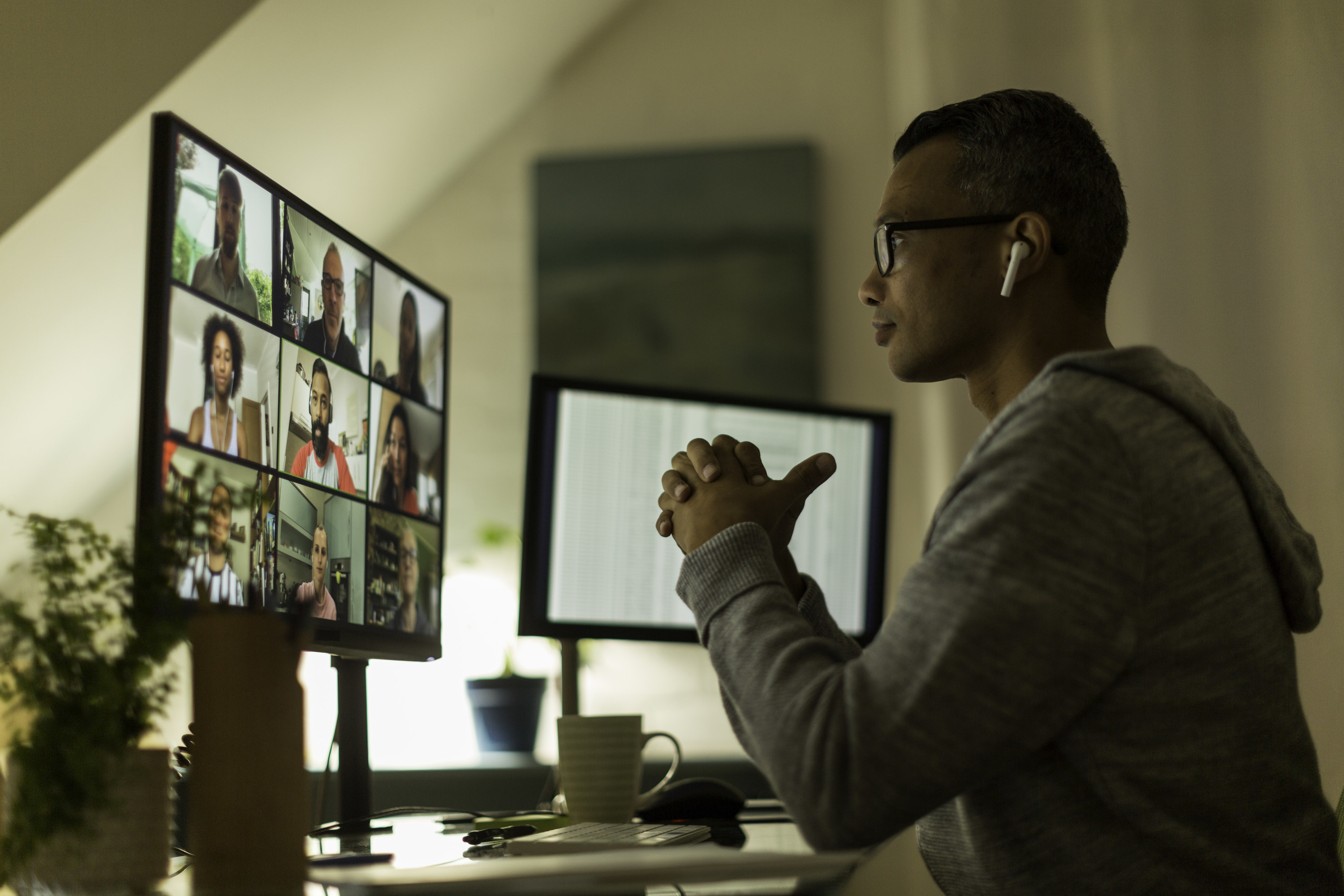 Man looking at screen while on a work call