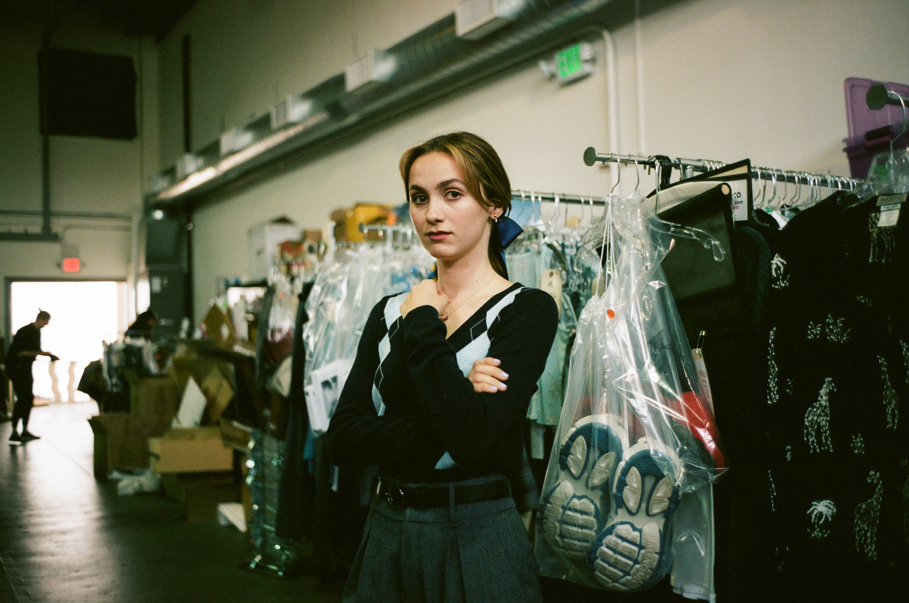 Maude Apatow on set in front of costumes