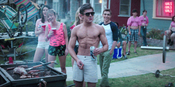 Shirtless Zac Efron as Teddy taunts his neighbor with a sausage in &quot;Neighbors&quot;