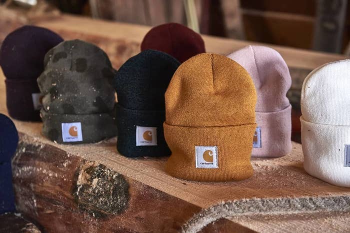a set of carhartt toques on a wooden bench