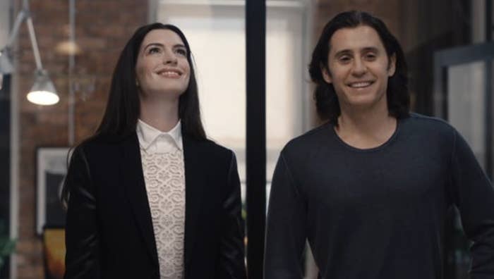 Anne Hathaway and Jared Leto smiling while walking