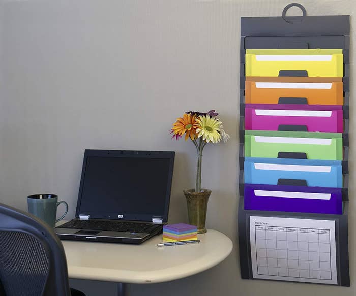a set of hanging file folders, each in a different colour